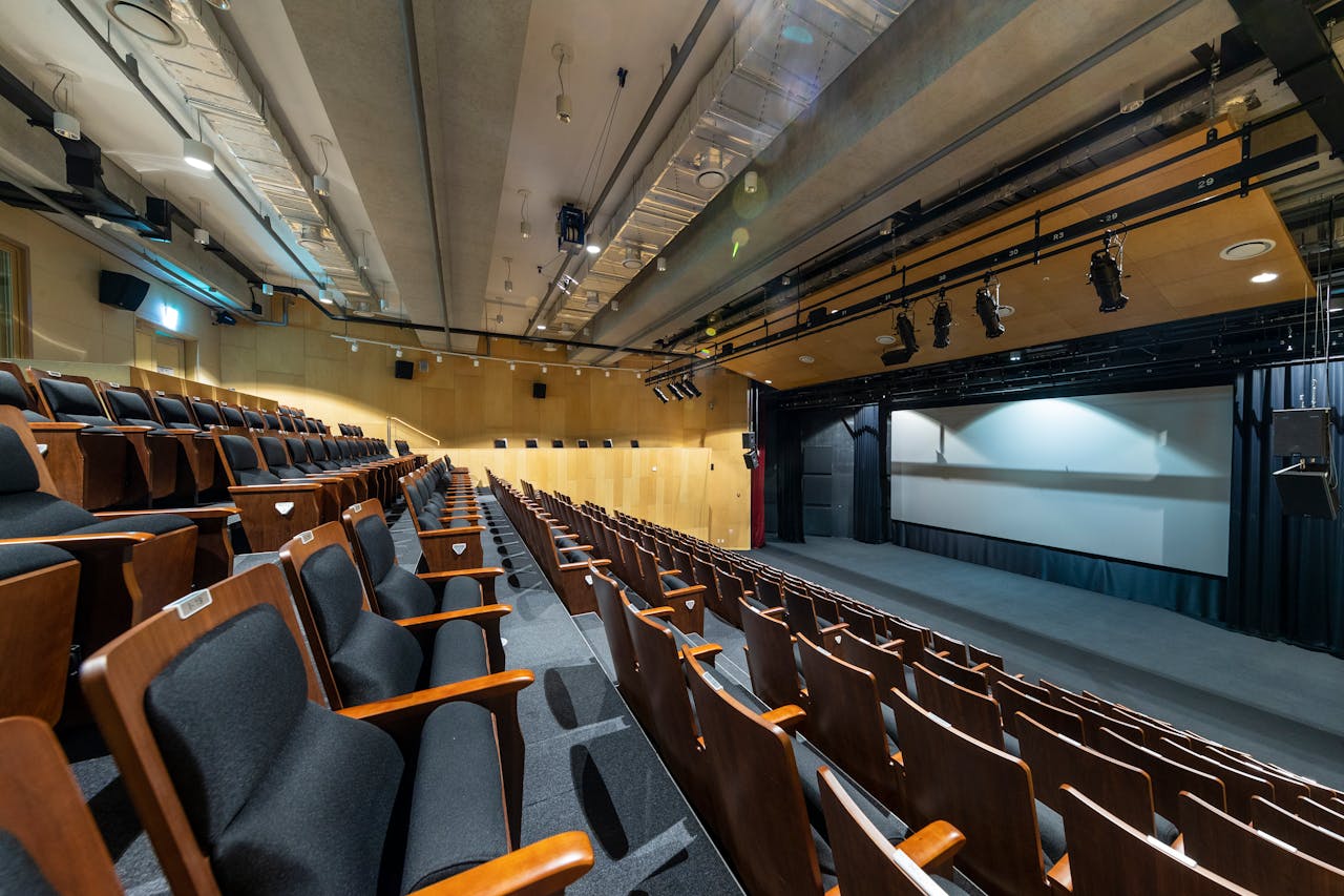 Theater interior with room acoustics treatment for enhanced sound performance